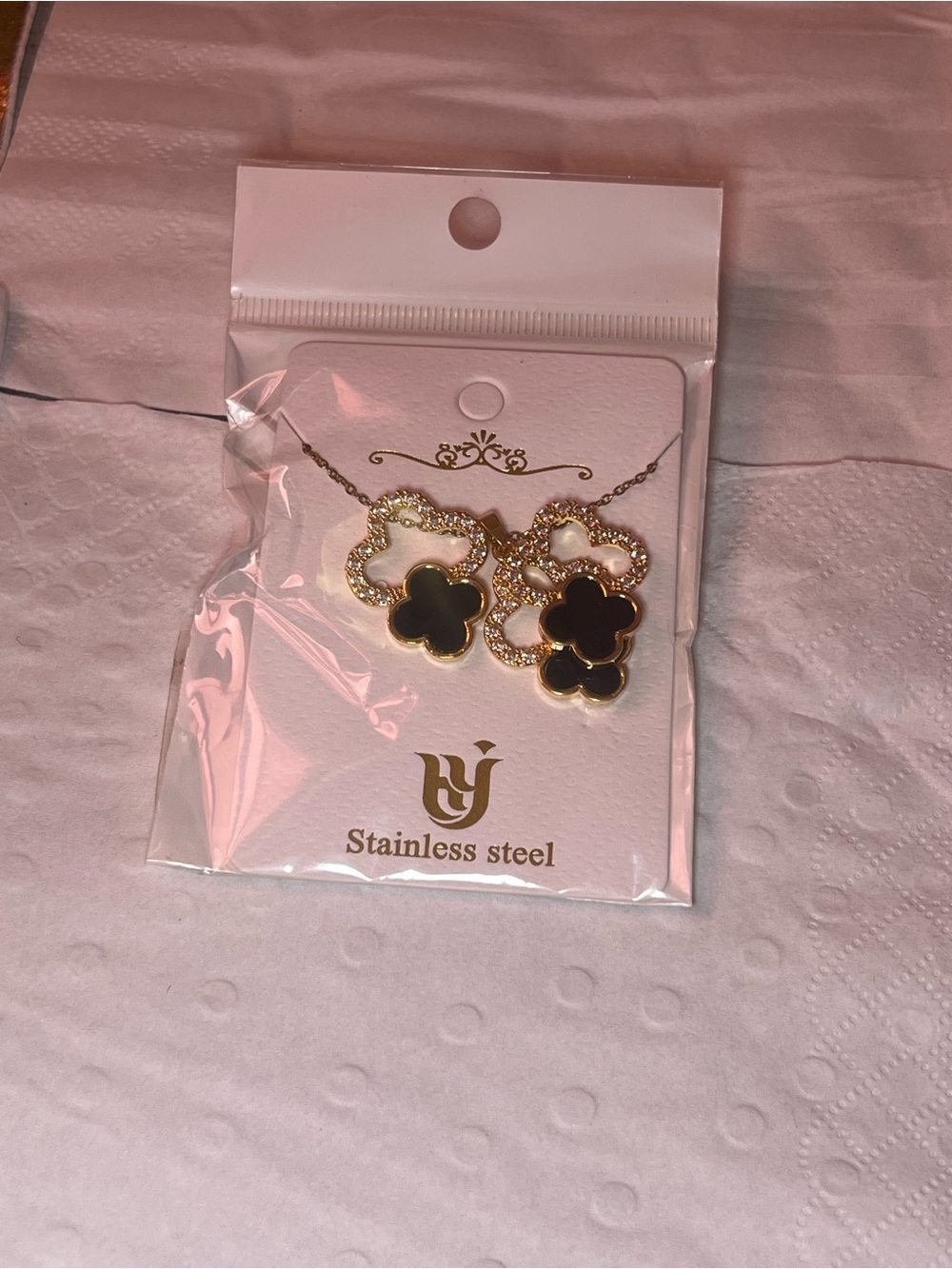Gold Clover Drop Earrings with Black Enamel and Crystal Accents.